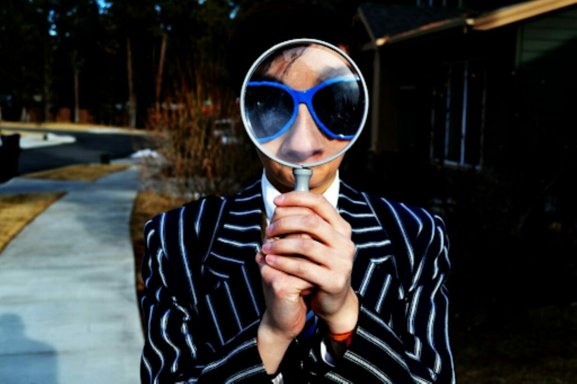 Magnifying glass held up to someone's face. Why Self-Awareness is Important in Leadership Development