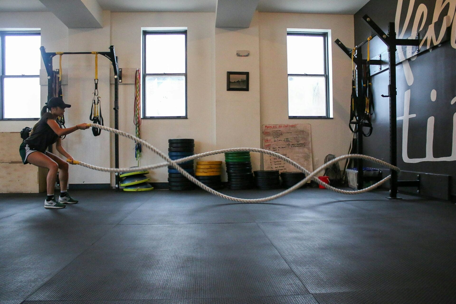 Woman doing workout ropes in a gym