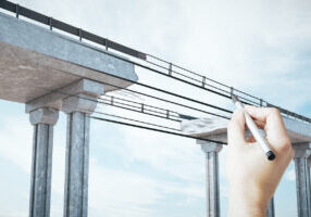 Hand drawing destroyed bridge on abstract sky background. Engineering and project concept.