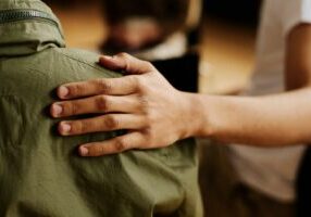 Hand-of-young-supportive-man-consoling-his-friend